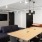 co-working space with seating tables and a tv