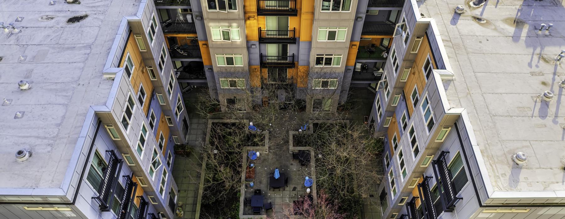 a building with trees and plants in front of it